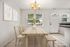 Bright dining area with elegant wooden table and chairs, soft lighting, and charming wall art, offering a warm and inviting atmosphere.