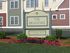Charming apartment complex at The Meadows with vibrant garden and modern architecture on 2 Village Way.