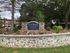 Charming entrance to Davis Commons with vibrant landscaping and elegant stonework at 165 Carl Avenue.