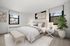 Bright and inviting bedroom with modern decor, featuring a cozy bed and two large windows allowing natural light to flood the space.