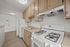 Bright and welcoming kitchen with modern beige cabinetry, sleek countertops, and a gas stove, perfect for stylish living.