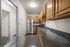 Modern kitchen with sleek granite countertops, stainless steel appliances, and warm wooden cabinets, perfect for culinary enthusiasts.