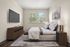 Bright and inviting bedroom featuring a plush bed, elegant decor, modern dresser, and large window with scenic views.