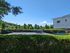 Inviting outdoor patio area featuring lush greenery, blue benches, and scenic views, perfect for relaxation and gatherings.