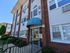 Charming brick apartment building exterior with modern windows, an inviting entrance, and manicured landscaping.