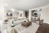 Elegant living space featuring a cozy sectional sofa, stylish dining area, and a modern open kitchen with bar seating.
