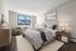 Elegant bedroom with a modern design, featuring a cozy bed, stylish furniture, and a bright window view.