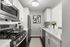 Sleek modern kitchen featuring stainless steel appliances, contemporary cabinetry, and elegant quartz countertops, showcasing a bright and inviting culinary space.
