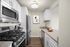 Modern kitchen with sleek stainless steel appliances, elegant cabinetry, and a cozy atmosphere.