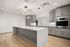 Sleek modern kitchen featuring a marble island, stainless steel appliances, and elegant cabinetry, perfect for entertaining.