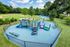 Inviting playground with vibrant equipment surrounded by lush greenery and adjacent to a baseball field, perfect for family fun.