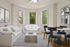 Bright and spacious living room with large windows, modern decor, cozy seating, and stylish dining area.