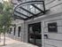 Modern apartment building entrance with stylish glass canopy and sleek signage at Atrio Boston.