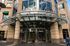 Elegant entrance of a modern commercial building with glass and steel elements, offering a welcoming atmosphere.