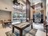 Luxurious lounge with high ceilings, elegant lighting, and a stylish billiards table, offering a perfect blend of relaxation and entertainment.