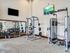 Modern fitness room featuring state-of-the-art equipment, wall-mounted TV, and stylish mirrored wall.