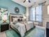 Elegant bedroom with modern decor, featuring a plush bed, stylish lamps, and a serene ambiance.