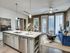 Chic open-concept apartment with a modern kitchen island, stylish living area, and inviting natural light.