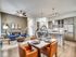 Contemporary open-concept apartment with a chic dining area, vibrant living room, and modern kitchen, ideal for stylish urban living.