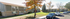 Charming suburban apartment complex with lush green lawns, classic architecture, and vibrant autumn trees.