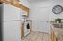 Charming kitchen with granite countertops, wooden cabinetry, and modern appliances in a bright, inviting space.