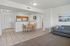 Inviting open-plan living space with cozy gray sofa, stylish kitchen, and charming dining area.
