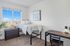 Bright and cozy bedroom with a scenic view, featuring a lofted bed, sleek desk, and elegant decor for a perfect study retreat.