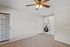 Bright laundry area with modern washer and dryer, featuring stylish cabinetry and ceiling fan in a cozy room.