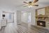 Inviting apartment interior showcasing a cozy fireplace, modern kitchen, and elegant wood flooring.