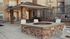 Inviting outdoor patio area with comfortable seating around a stylish stone fire pit, perfect for relaxation and social gatherings.