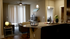Inviting apartment interior with elegant open-concept living area, modern kitchen island, and cozy lounge space, enhanced by warm lighting and stylish decor.