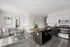 Modern apartment interior with sleek kitchen, cozy living area, and chic decor, perfect for comfortable city living.