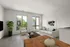 Bright and modern living room with large windows, stylish furnishings, and contemporary artwork.