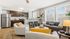 Bright and modern living area with large windows, cozy seating, stylish kitchen, and elegant decor.