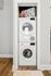Compact laundry nook with a sleek stacked washer and dryer, offering efficient use of space and modern convenience.