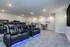 Luxurious home theater room featuring plush reclining seats, ambient lighting, and a stylish entertainment setup.