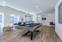 Modern game room featuring a stylish pool table, lounge seating, and a contemporary decor aesthetic.