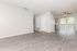 Bright and airy apartment interior featuring elegant laminate flooring, modern ceiling fan, and expansive sliding glass doors.