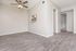 Modern apartment with wood-style flooring, neutral walls, and a ceiling fan, offering a bright and airy living space.