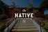 Inviting entrance of The Native Apartments with palm trees and a well-maintained pathway on a sunny day.
