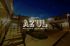 Charming courtyard view of East Azul Boutique Apartments, featuring modern architecture and a welcoming atmosphere under a twilight sky.
