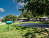 Inviting outdoor space featuring a well-kept green lawn, playful pet exercise area, and spacious shaded gazebos, perfect for enjoying sunny days.
