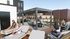 Vibrant rooftop lounge with modern seating and pergola, offering a perfect space for social gatherings and relaxation.