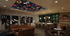 Chic lounge area with modern decor, vibrant ceiling design, and elegant bar counter.