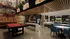 Vibrant entertainment room featuring a red pool table, air hockey, multiple gaming stations, and stylish seating, perfect for social gatherings.