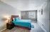 Inviting bedroom with modern flair, featuring a cozy double bed, stylish bedside table, and natural light streaming through the window.