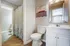 Bright and stylish bathroom with modern fixtures, a chic patterned shower curtain, and elegant wall art for a refreshing atmosphere.