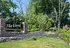 Inviting entrance of The Views at Mt. Airy, surrounded by lush greenery and elegant brickwork, promising a serene living environment.