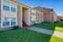 Charming brick apartment building with well-maintained lawn and inviting entryway.