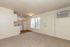 Bright and inviting apartment interior featuring an open living area with plush carpeting, a cozy kitchenette, and a large window allowing natural light to fill the space for a warm ambiance.